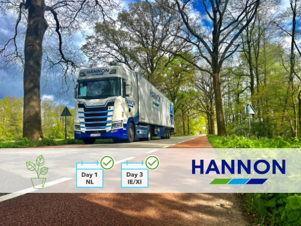 Lorry driving between field of trees