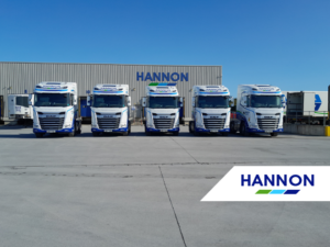 Fleet of Trucks in front of warehouse