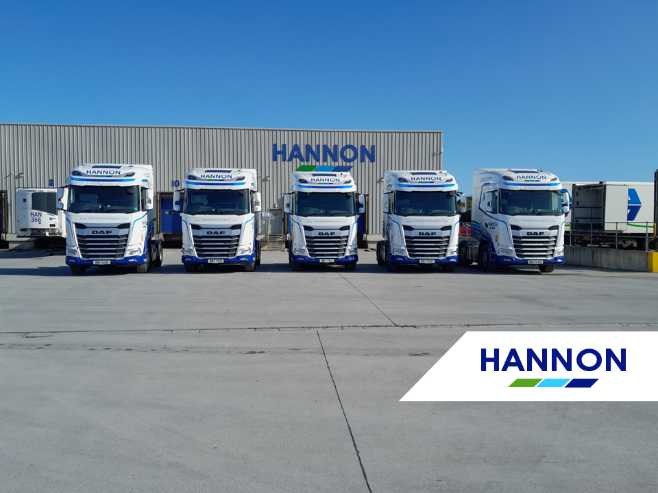 Fleet of Trucks in front of warehouse