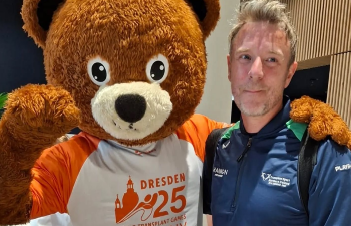 Man beside mascot