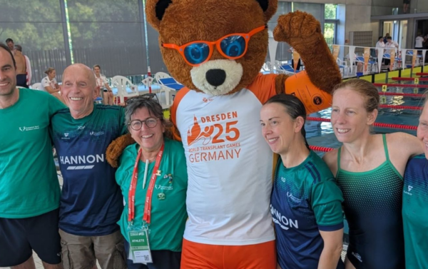 Group of people celebrating with mascot