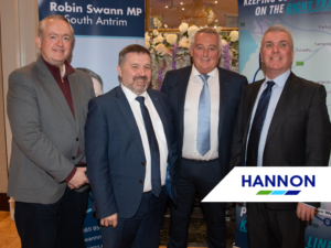 Four men in a group photo at an event