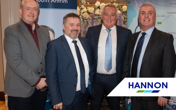 Four men in a group photo at an event